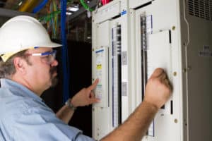 electrician checking something on elecrtrical panel