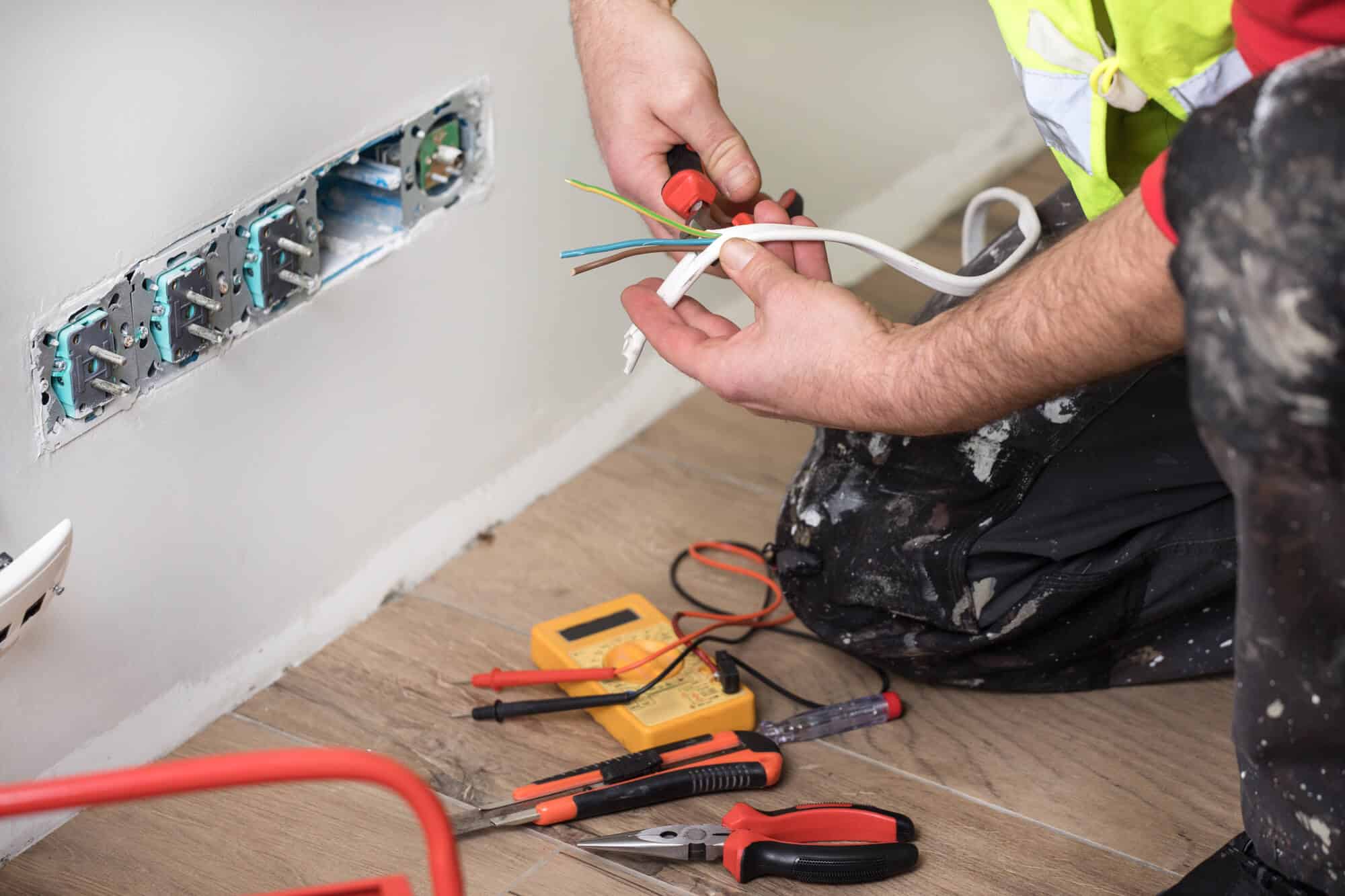 electrician installing wall wiring